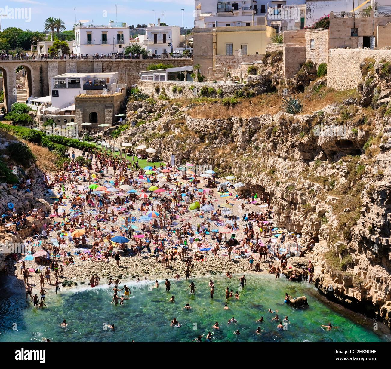 Polignano a Mare, Southern Italy province of Bari - famous beach Lama Monachile between steep cliffs and white buildings Stock Photo