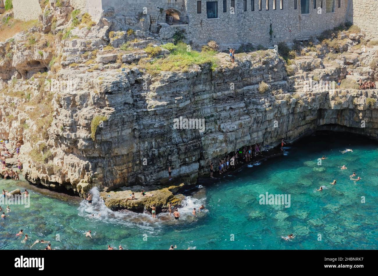 Polignano a Mare, Southern Italy province of Bari - famous beach Lama Monachile between steep cliffs and white buildings Stock Photo