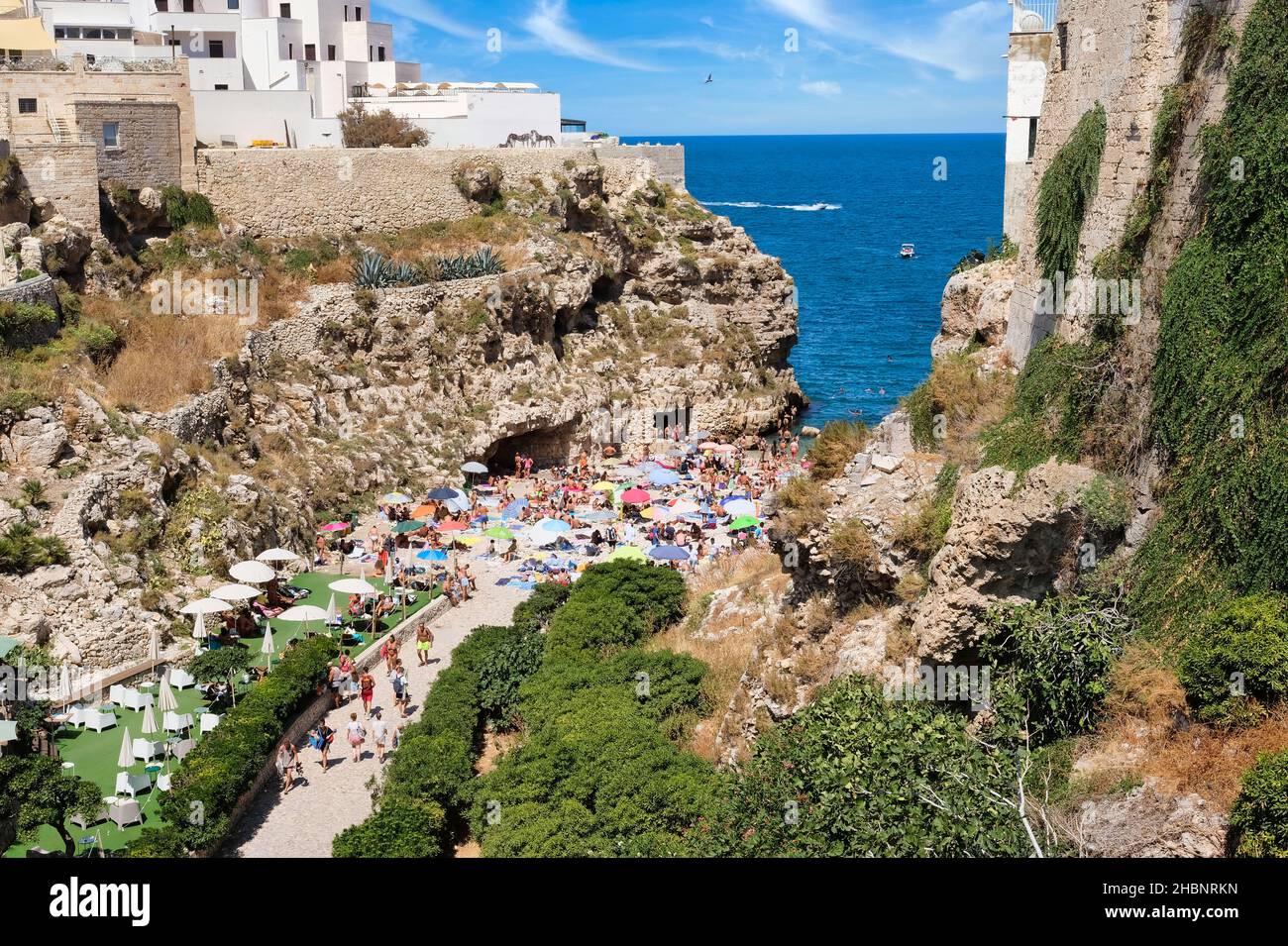 Polignano a Mare, Southern Italy province of Bari - famous beach Lama Monachile between steep cliffs and white buildings Stock Photo