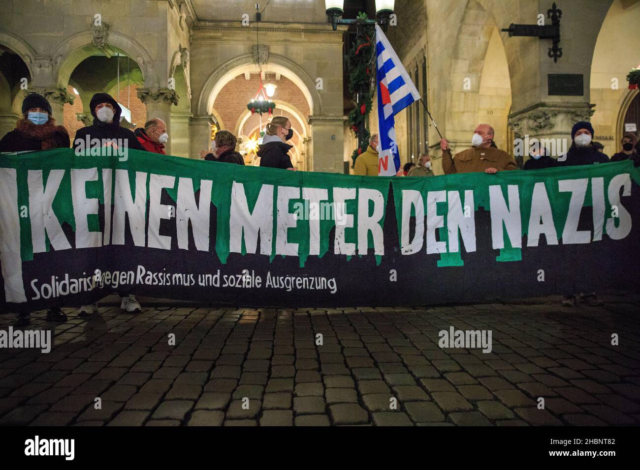Münster, NRW, Germany. 20th Dec, 2021. Protesters with a placard saying 'Keinen Meter den Nazis' (Don't give space to Nazis') against racism and social segregation. Activists and protesters from several organisations have congregated in the city centre, protesting against conspiracy theories, racism, anti-semitism and social segregation, and for vaccinations. Credit: Imageplotter/Alamy Live News Stock Photo