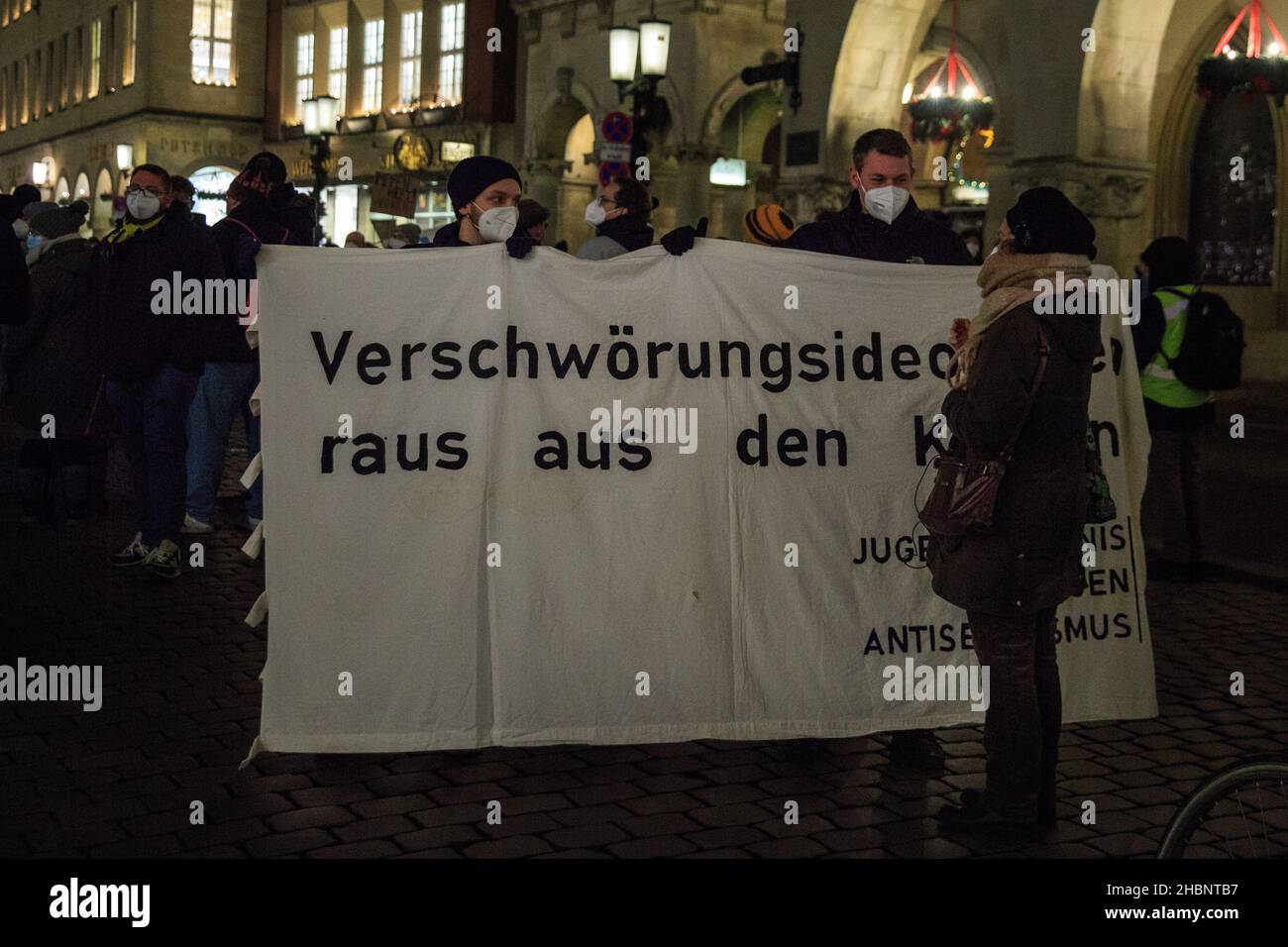 Münster, NRW, Germany. 20th Dec, 2021. Protesters with a placard urging to 'keep conspiracy ideologies out'. Activists and protesters from several organisations have congregated in the city centre, protesting against conspiracy theories, racism, anti-semitism and social segregation, and for vaccinations. Credit: Imageplotter/Alamy Live News Stock Photo