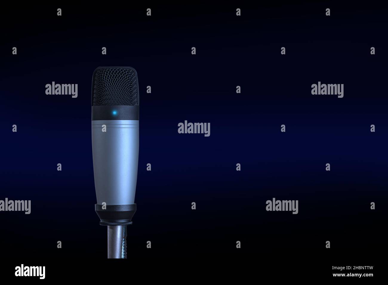 Condenser microphone isolated on dark background with copy space. Stock Photo