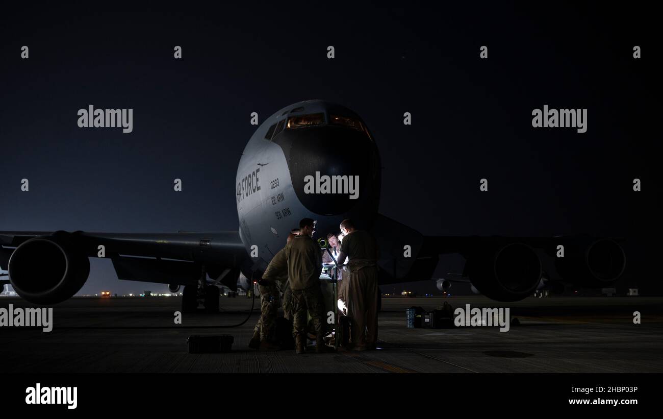 Aircrew members assigned to the 340th Expeditionary Air Refueling Squadron conduct a preflight brief outside of a U.S. Air Force KC-135 Stratotanker at Al Udeid Air Base Qatar, Dec. 9, 2021. The KC-135 delivers U.S. Air Forces Central a global reach aerial refueling capability to support joint and partner nation aircraft throughout the U.S. Central Command area of responsibility. (U.S. Air Force photo by Staff Sgt. Joseph Pick) Stock Photo