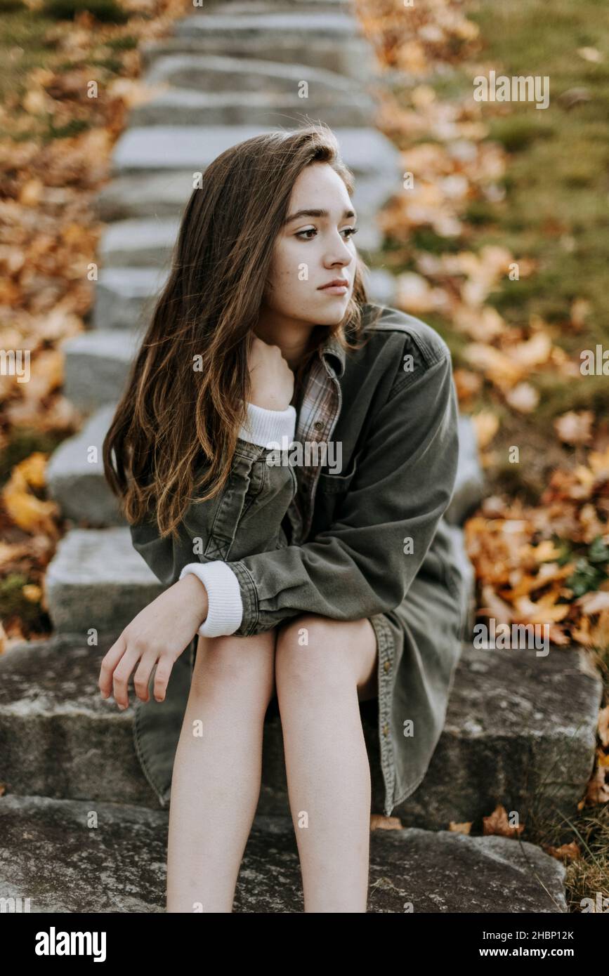 portrait of female teenager looking emotional outside in fall Stock Photo