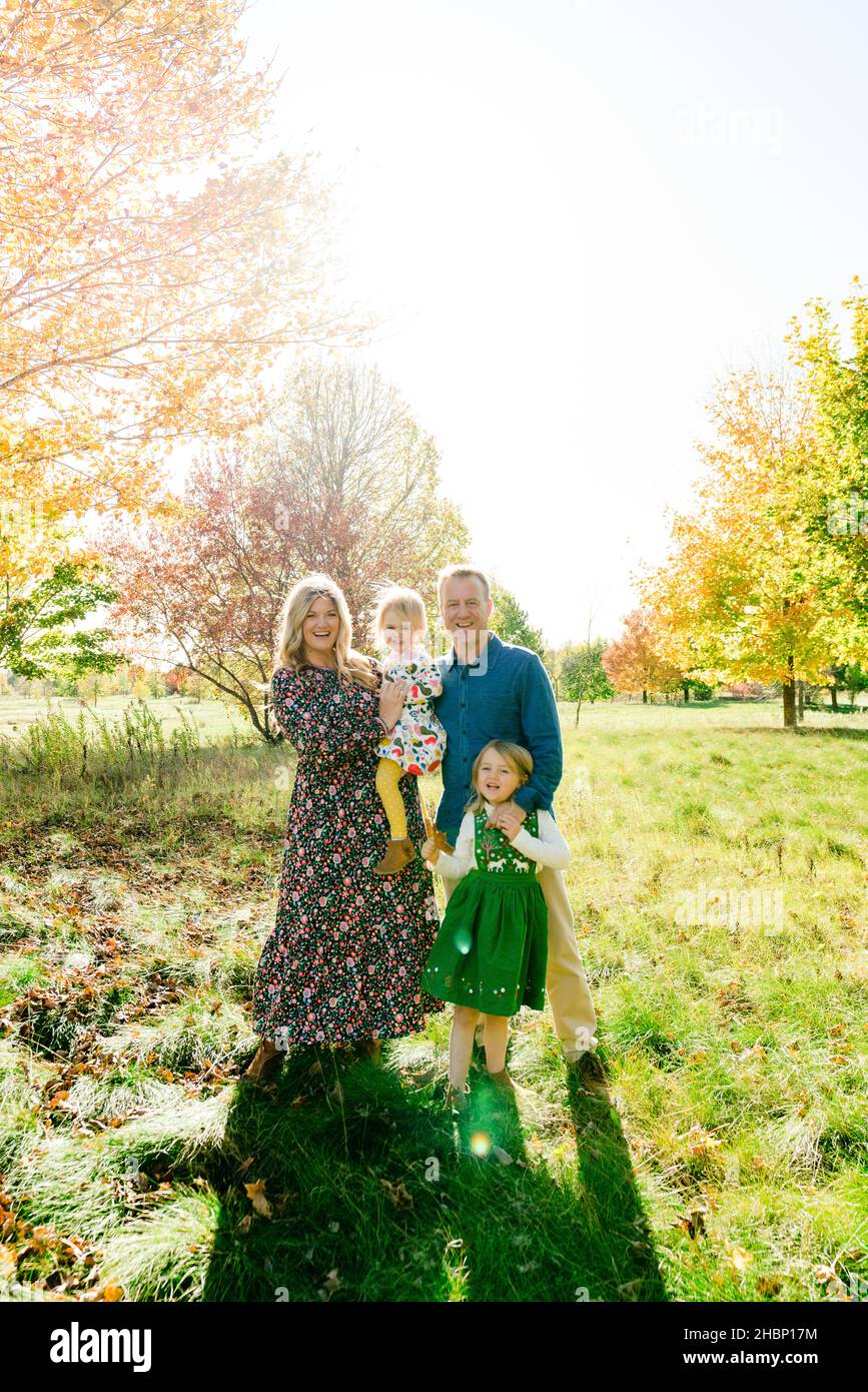 Fun smiling portrait of a family of four outdoors Stock Photo