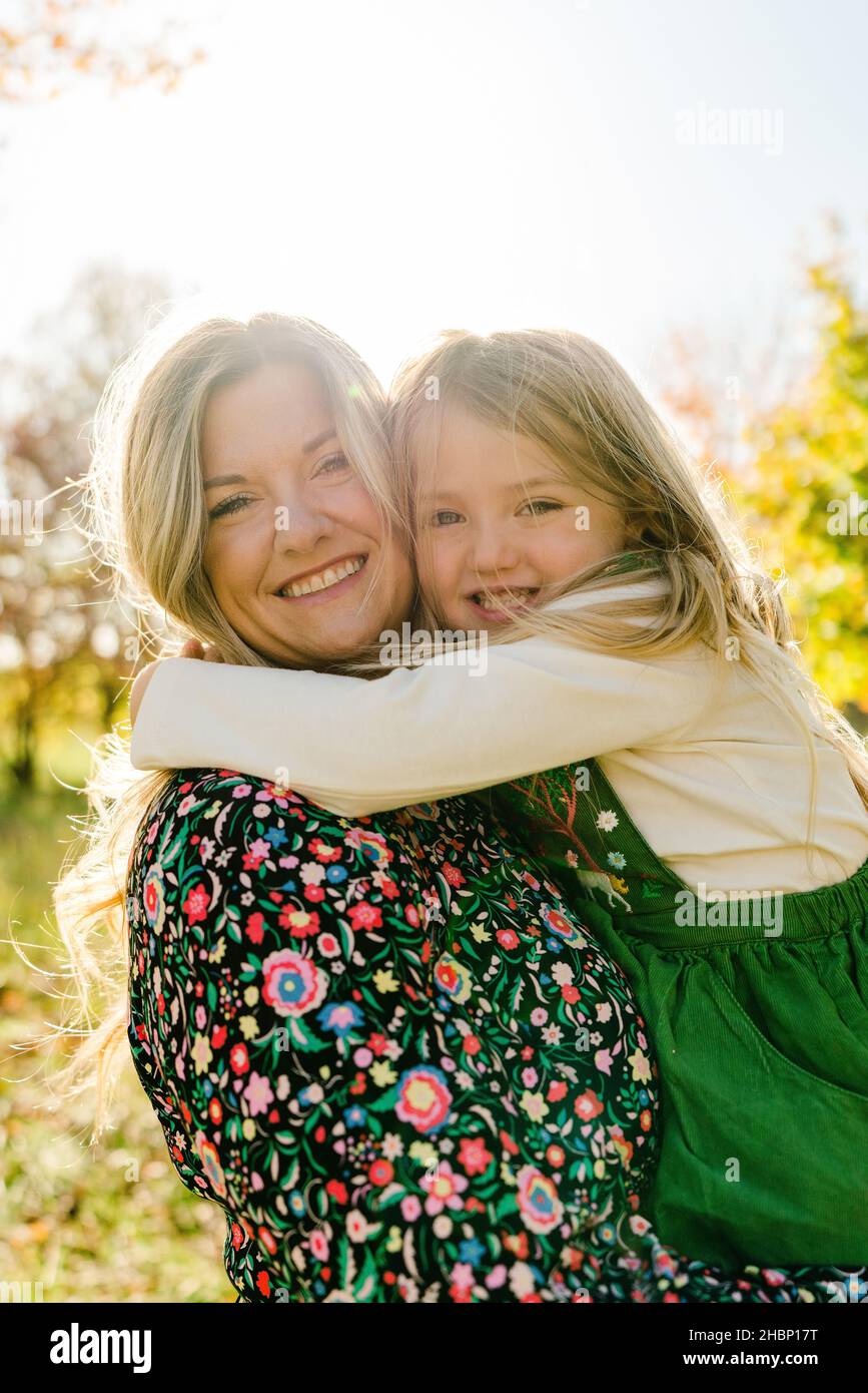 Straight on portrait of a mother holding her daughter Stock Photo