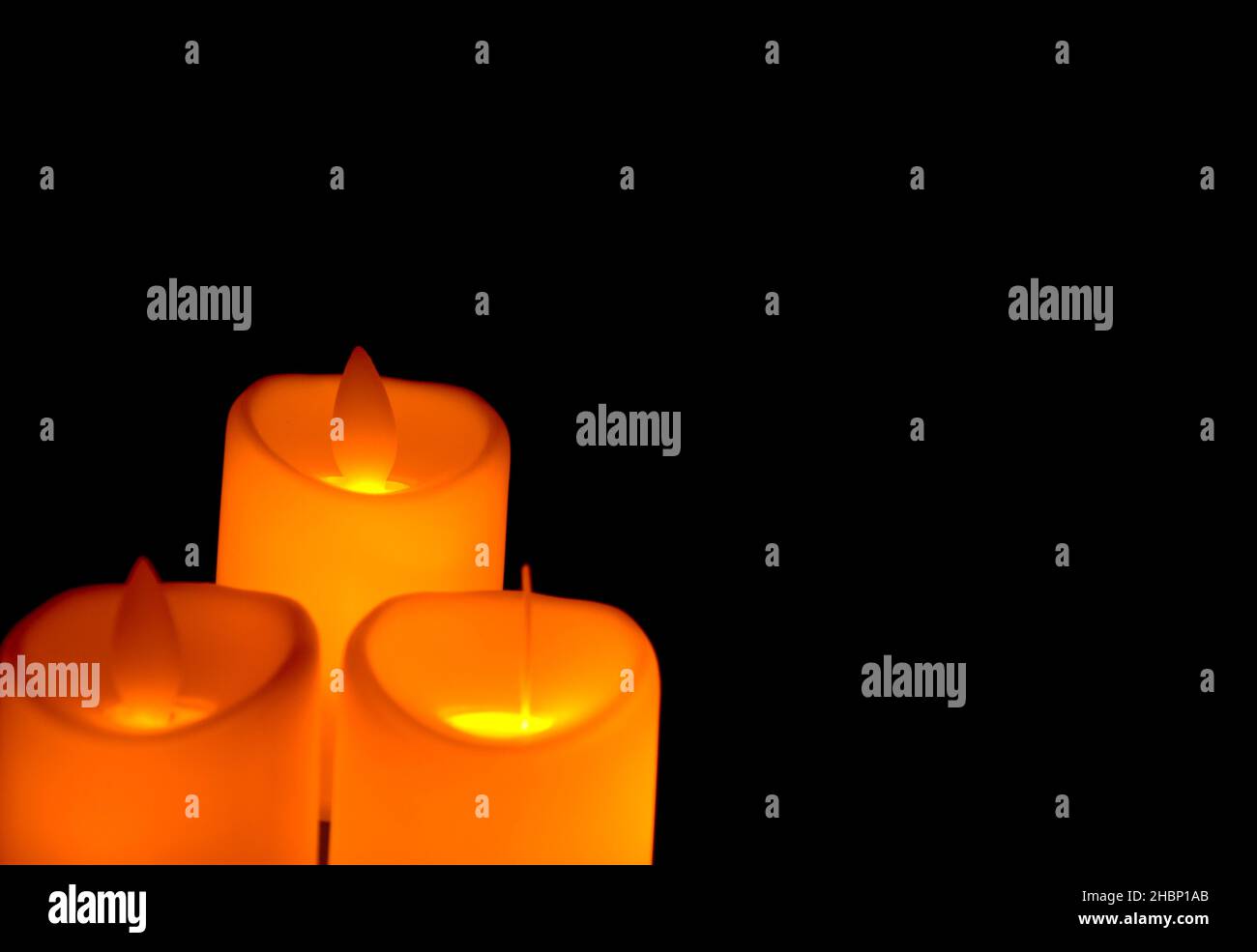 Orange candle with light shines in the shadows. Advent concept Stock Photo