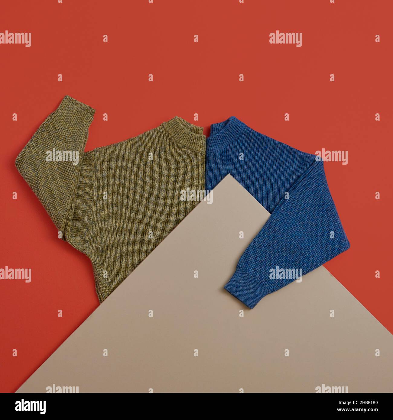 Yellow and Blue Sweater on Red Background Stock Photo