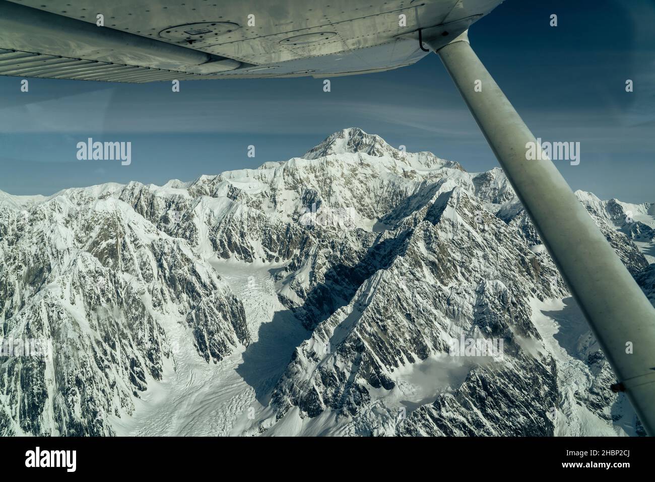 Beautiful snow covered mountains seen from small airplane Stock Photo