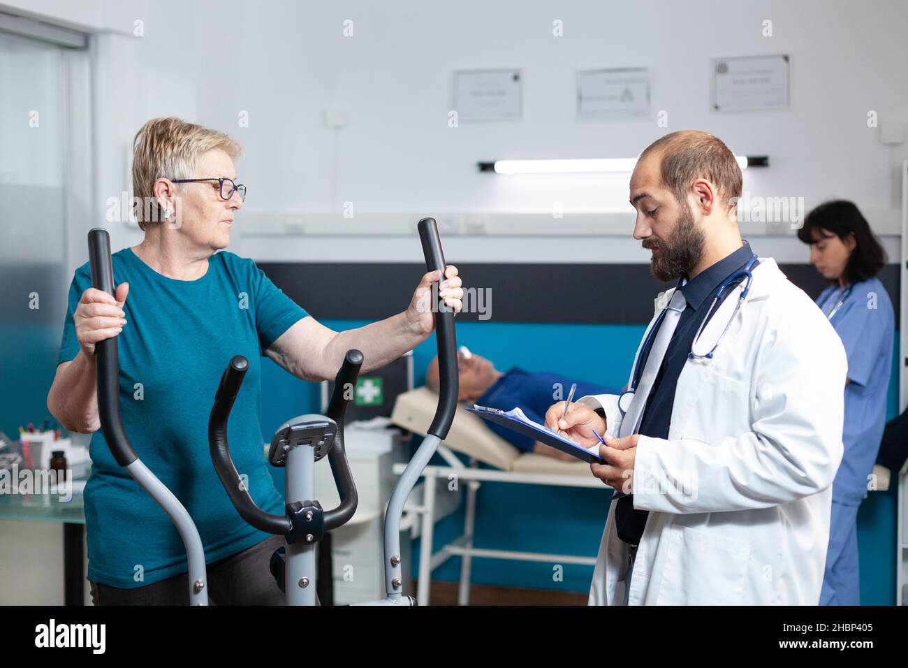 Old patient doing physical activity with stationary bicycle while