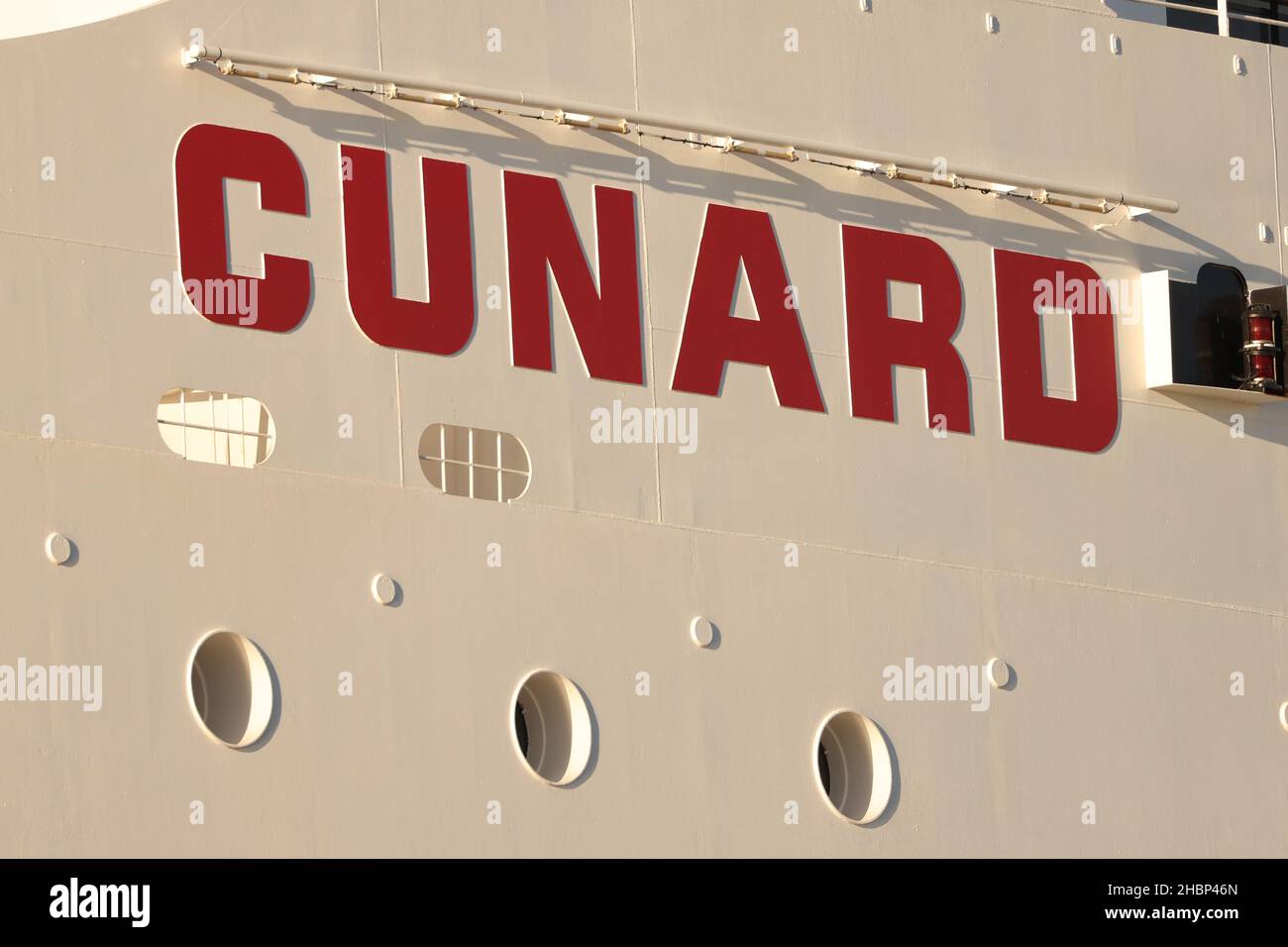 Signage is seen on the Queen Mary 2 cruise ship by Cunard Line, owned by Carnival Corporation & plc. as it is docked at Brooklyn Cruise Terminal in Brooklyn, New York City, U.S., December 20, 2021. REUTERS/Andrew Kelly Stock Photo