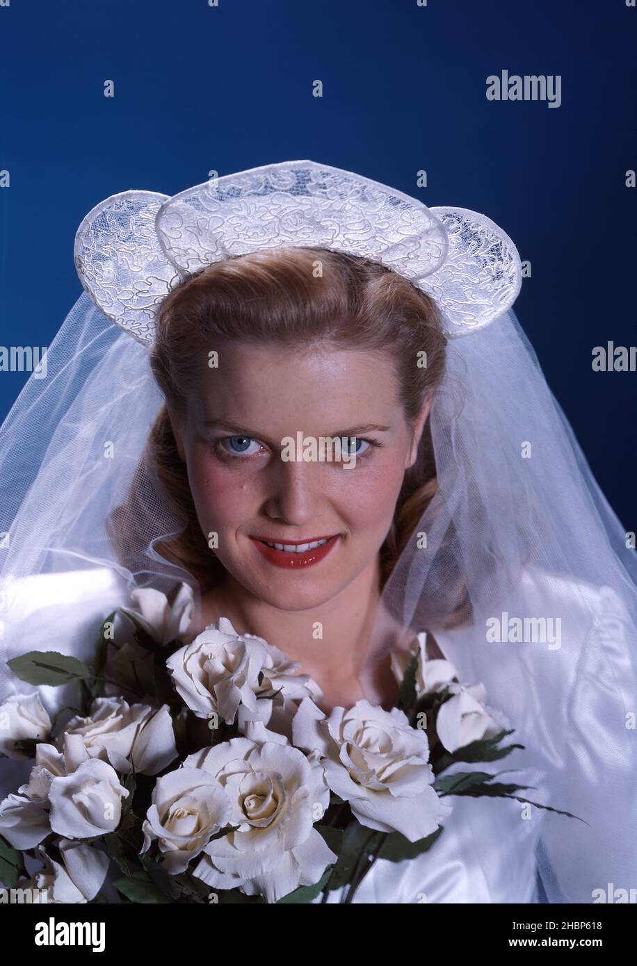Close up portrait of bride holding white roses Stock Photo