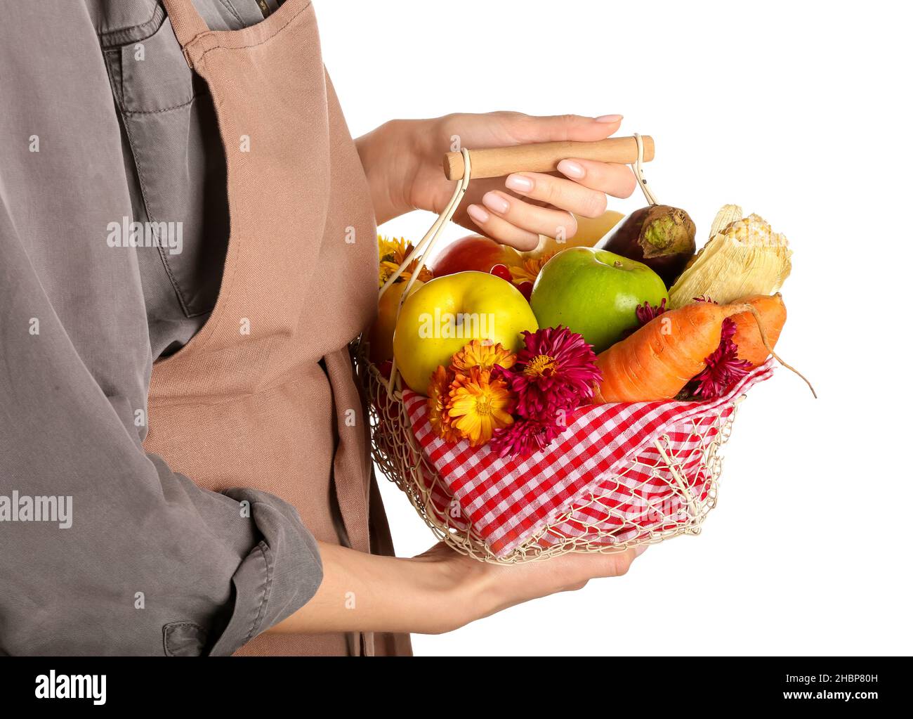 Woman holding basket with different healthy food on white background ...
