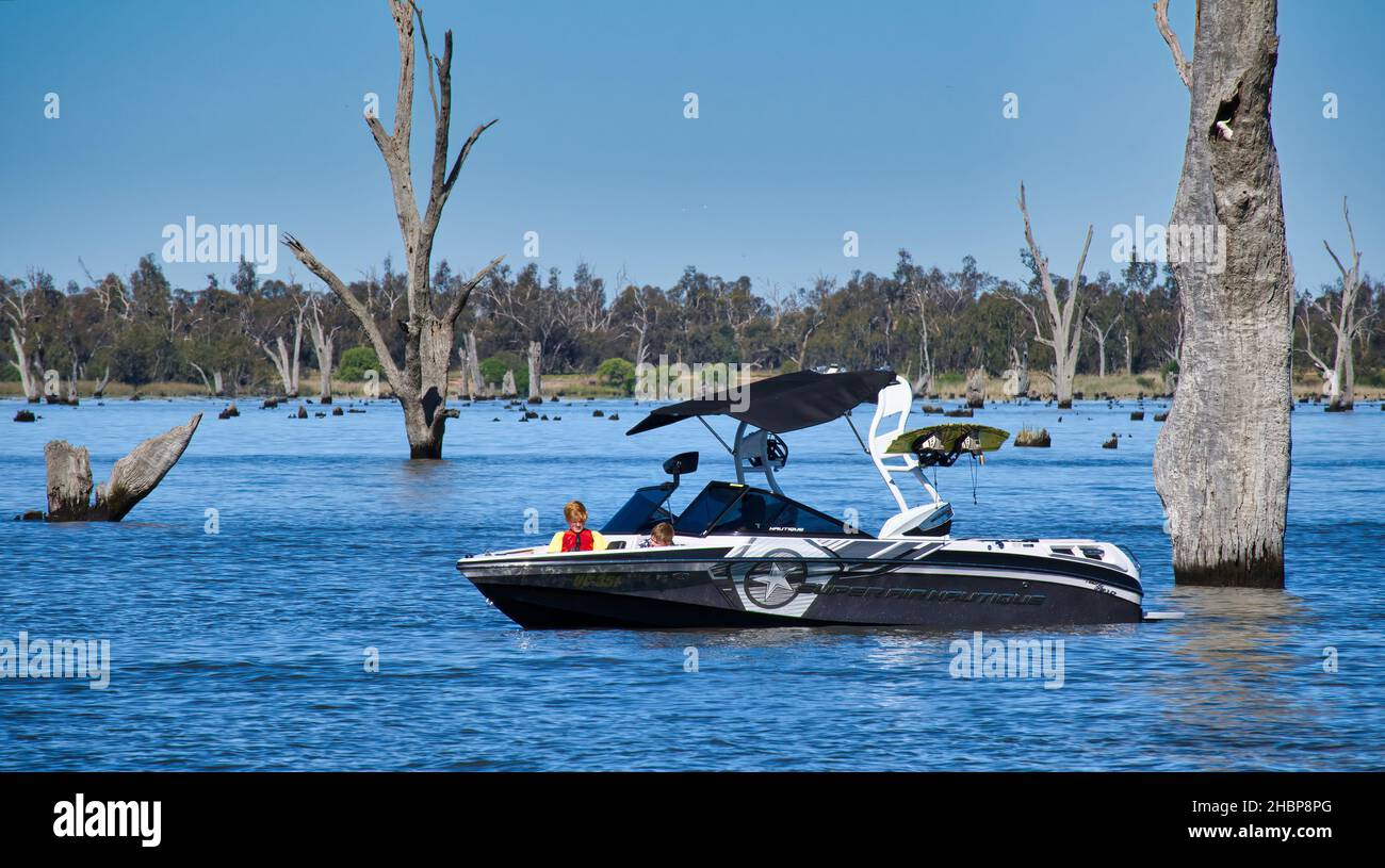 Mulwala, New South Wales Australia - October 31 2021: Wakeboarding boat with father and two kids on Lake Mulwala NSW Australia Stock Photo
