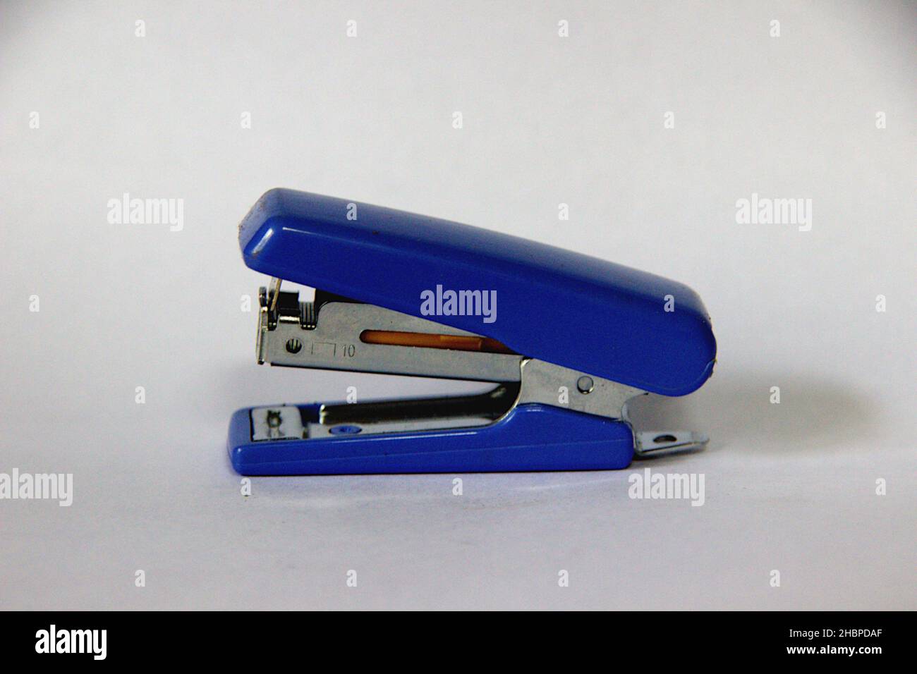 Blue color mini stapler used for stitching packages or packets isolated on white background Stock Photo