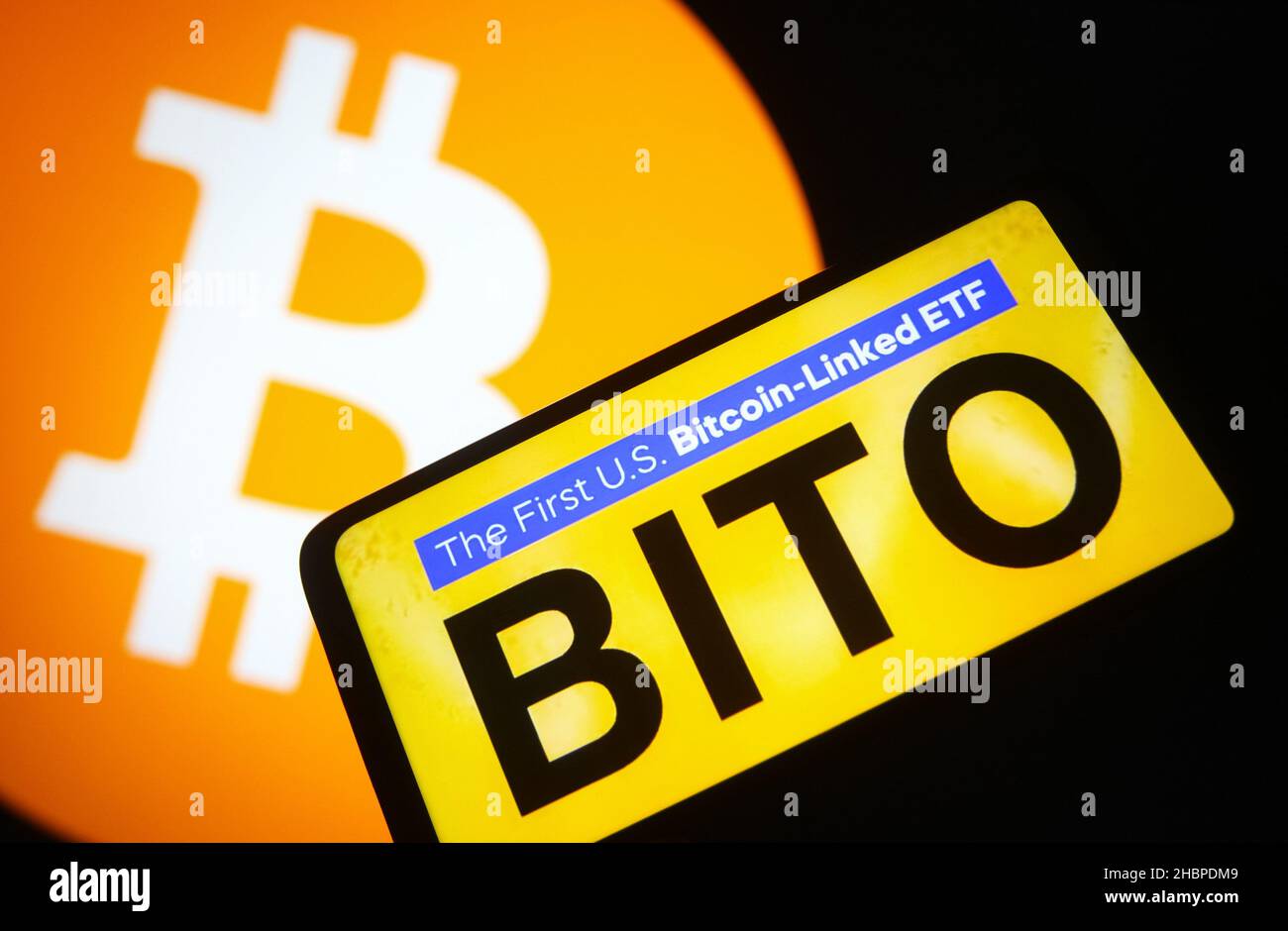 In this photo illustration, a ProShares Bitcoin Strategy ETF (BITO) logo of  the first U.S. bitcoin-linked ETF is seen on a smartphone screen and Bitcoin  cryptocurrency sign in the background. (Photo by