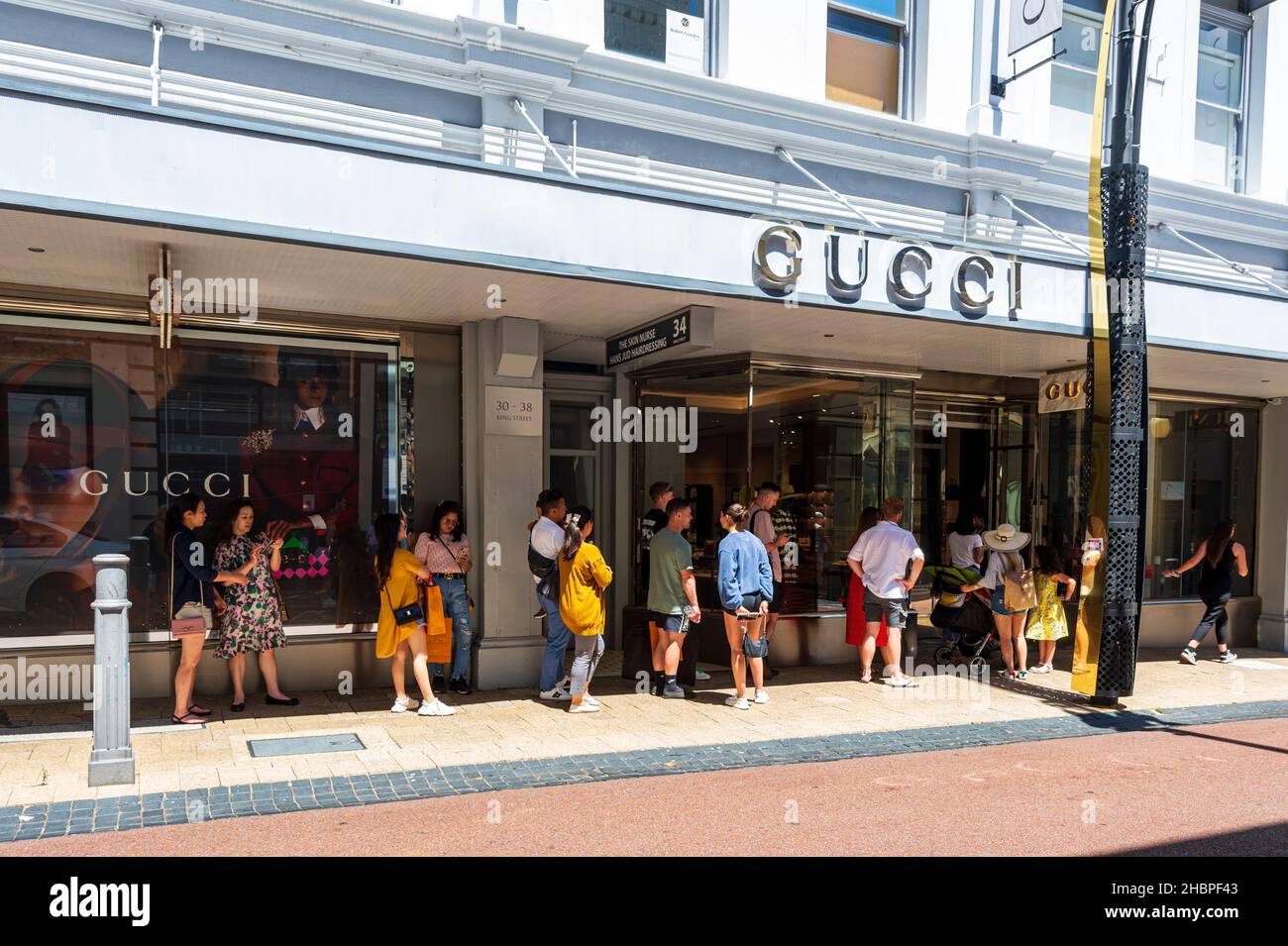 People queueing up for luxury goods at the Gucci store in King Street at Christmas, Perth, Western Australia, WA, Australia Stock Photo