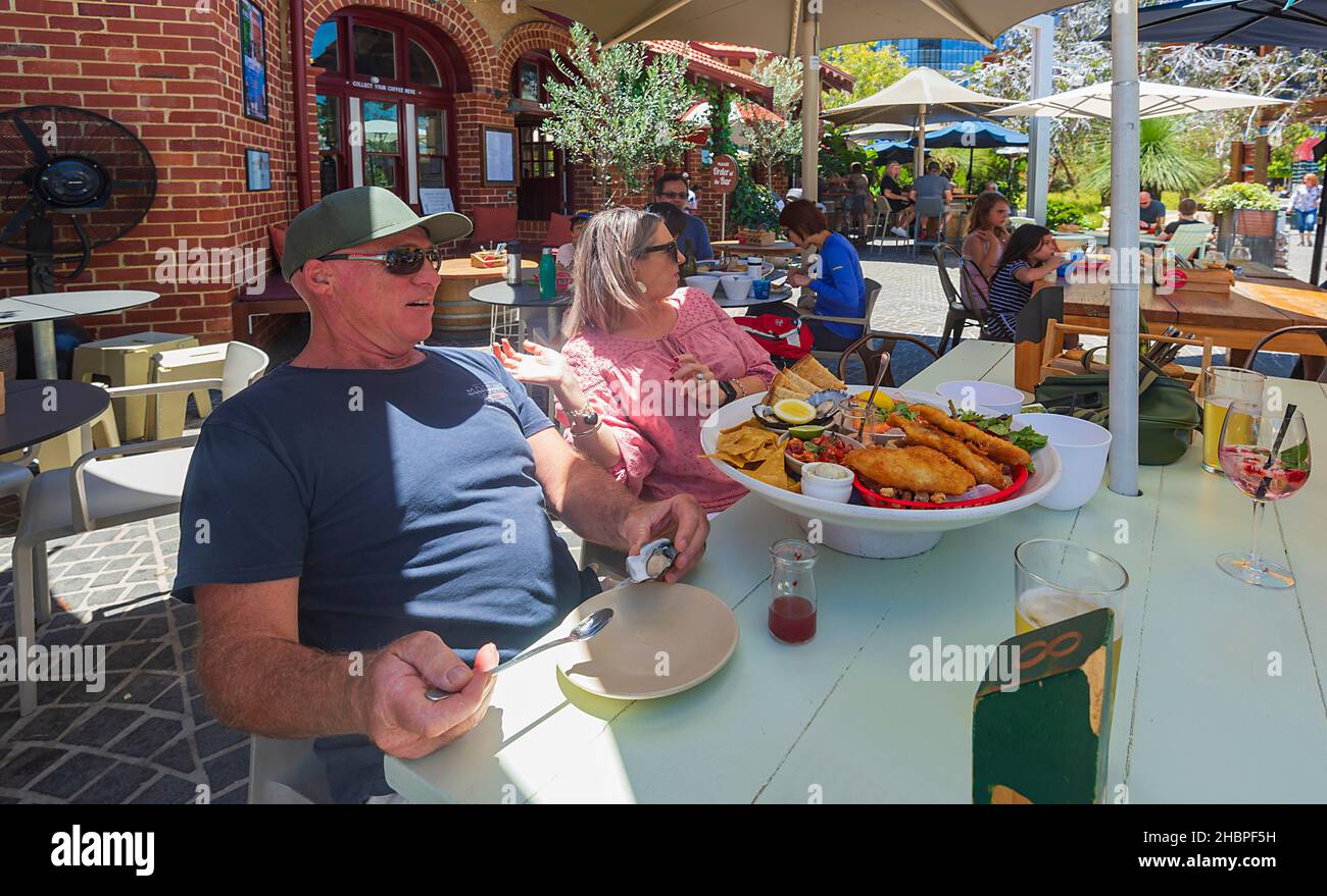 Couple sat in front of a large seafood platter at The Island on