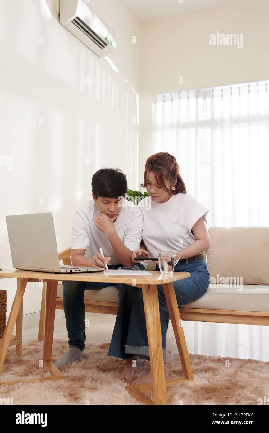 Pensive couple filling tax forms or health insurance claim form