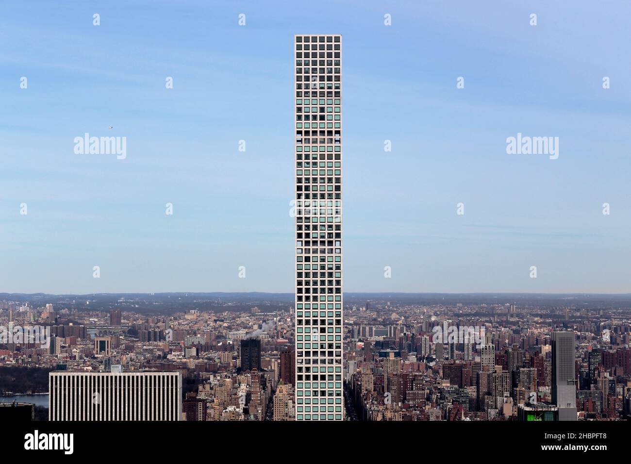 432 Park Ave, New York, NY. View of a supertall, skinny residential condominium skycraper against a sunny sky. Stock Photo
