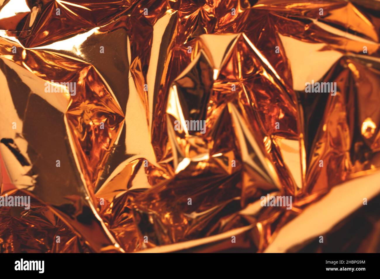 Blurred golden foil luxury texture. Defocused surface. Stock Photo