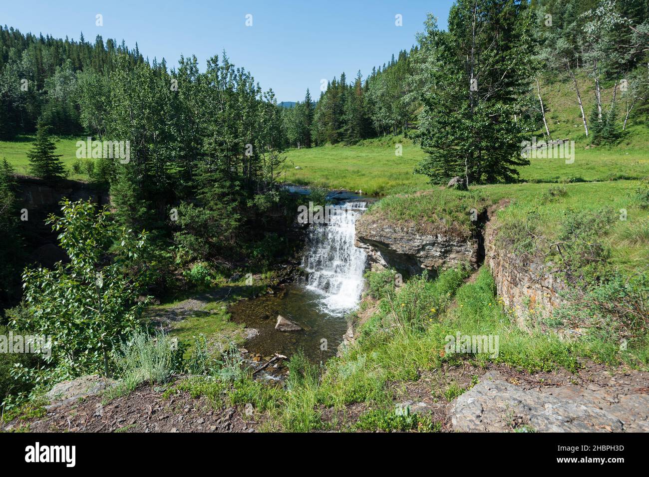 Cascading waterfall on a creek in the foothills of the Rocky Mountains Stock Photo