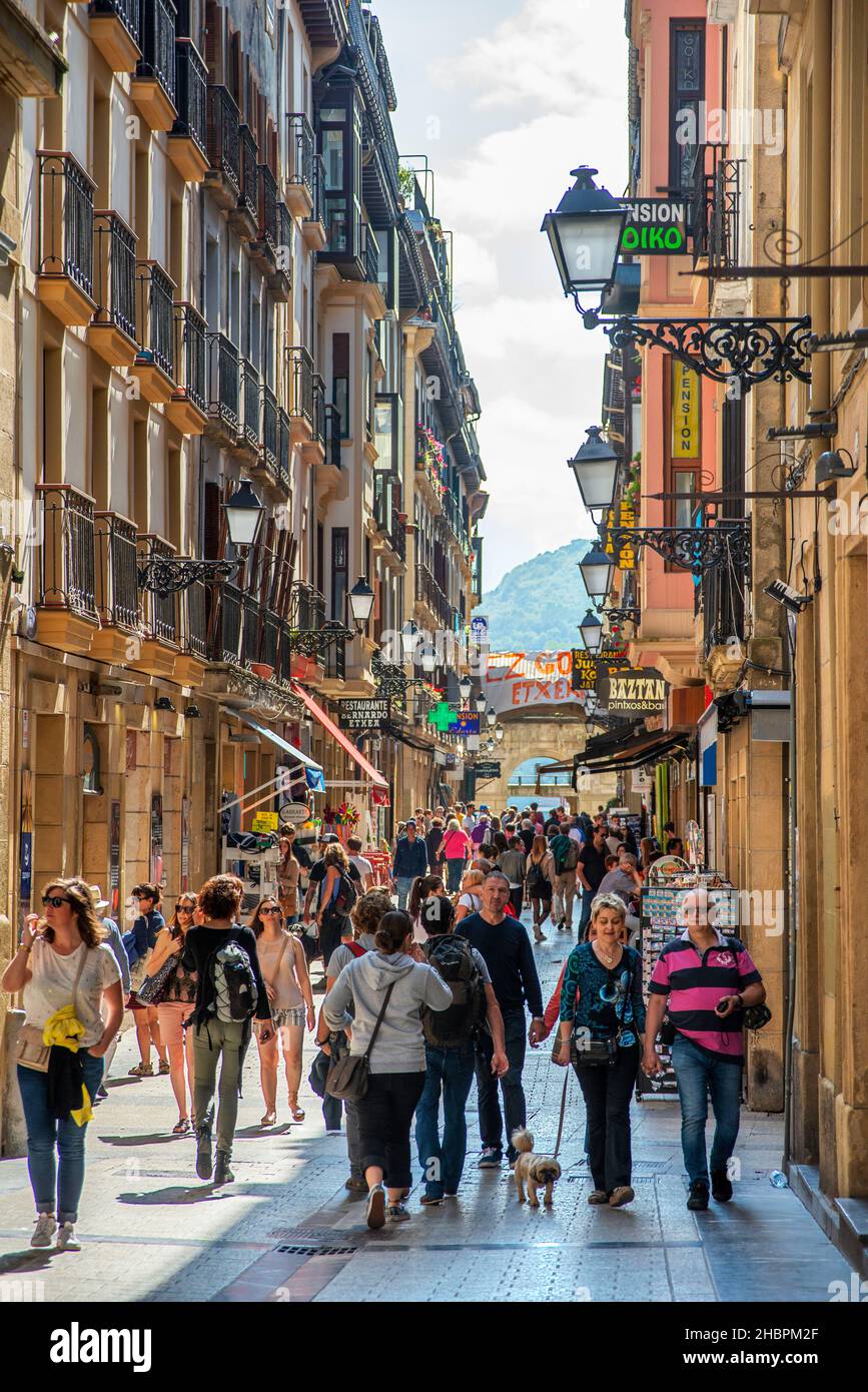 Fermin Calbeton street adorned with the city flag, with San Vicente church in background, located in Parte Vieja, San Sebastian Old Town. Spain Stock Photo