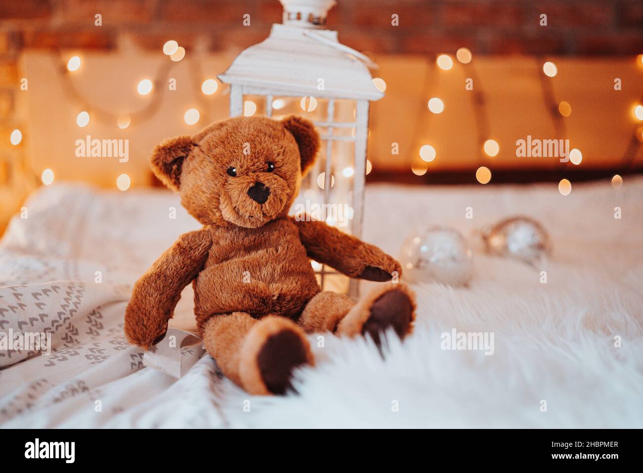 Teddy bear and christmas decorations on red background. Stock Photo