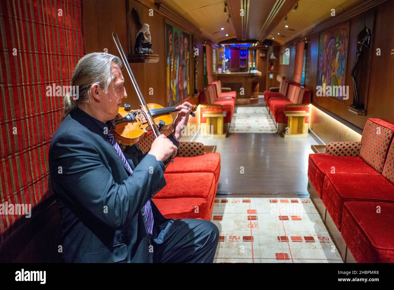Inside of Transcantabrico Gran Lujo luxury train travellong across northern Spain, Europe. Interior of restaurant car. Violin live music. Stock Photo