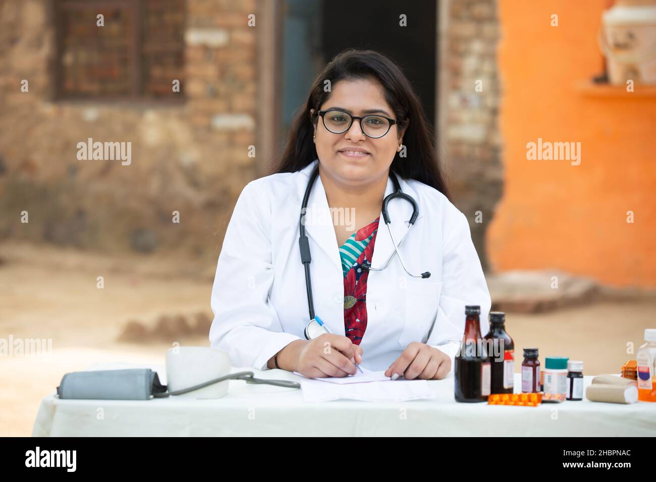 Portrait of Young Indian Female Doctor wear Stethoscope write ...