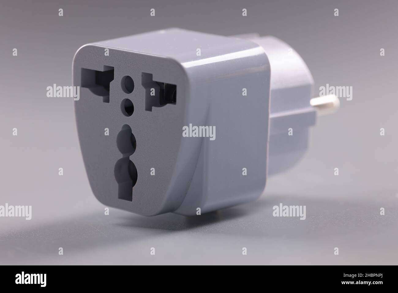 Closeup of universal white plugs adapter, adapter to put in sockets
