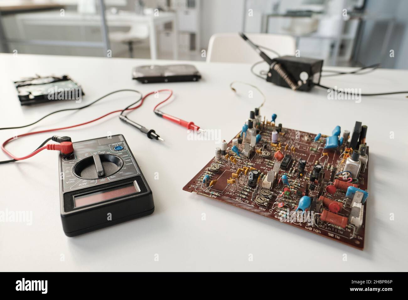 Motherboard of computer and transmission device with electric tweezers on workplace of repairman