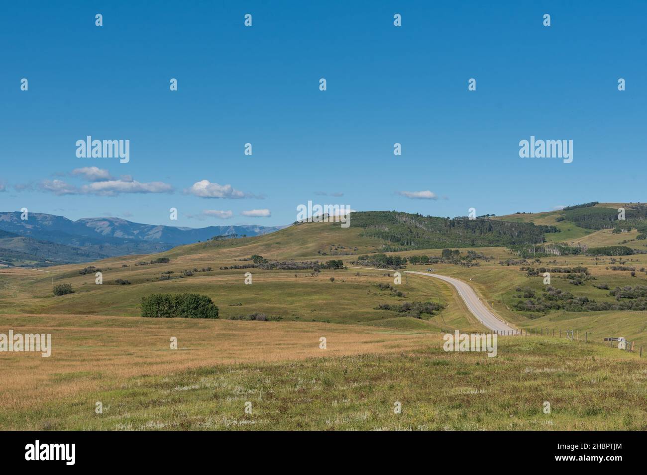 Scenic farmland in the prairies and foothills at the base of the Rocky Mountains in Alberta Canada Stock Photo