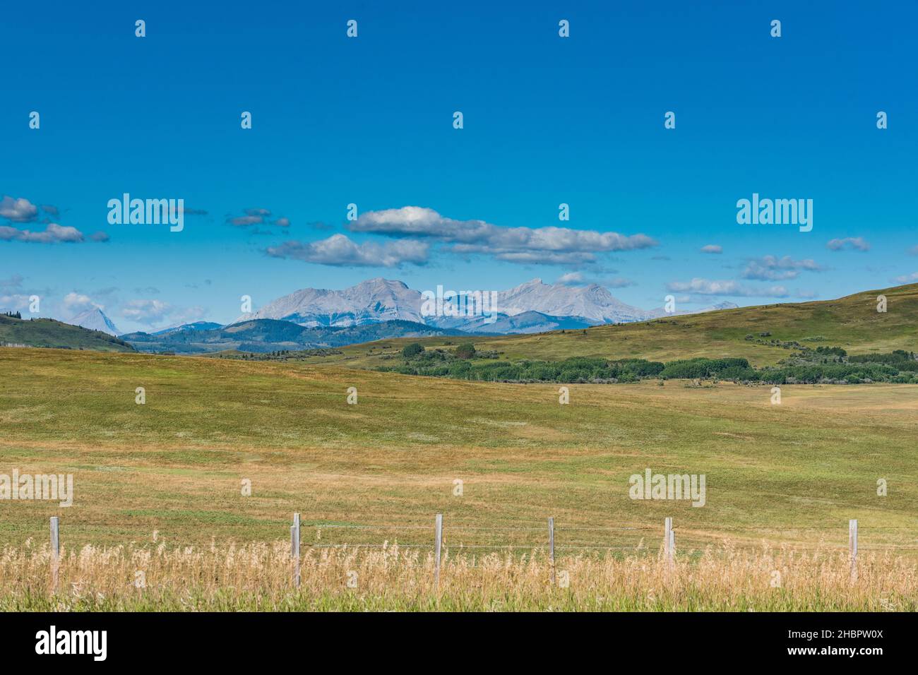 Scenic farmland in the prairies and foothills at the base of the Rocky Mountains in Alberta Canada Stock Photo