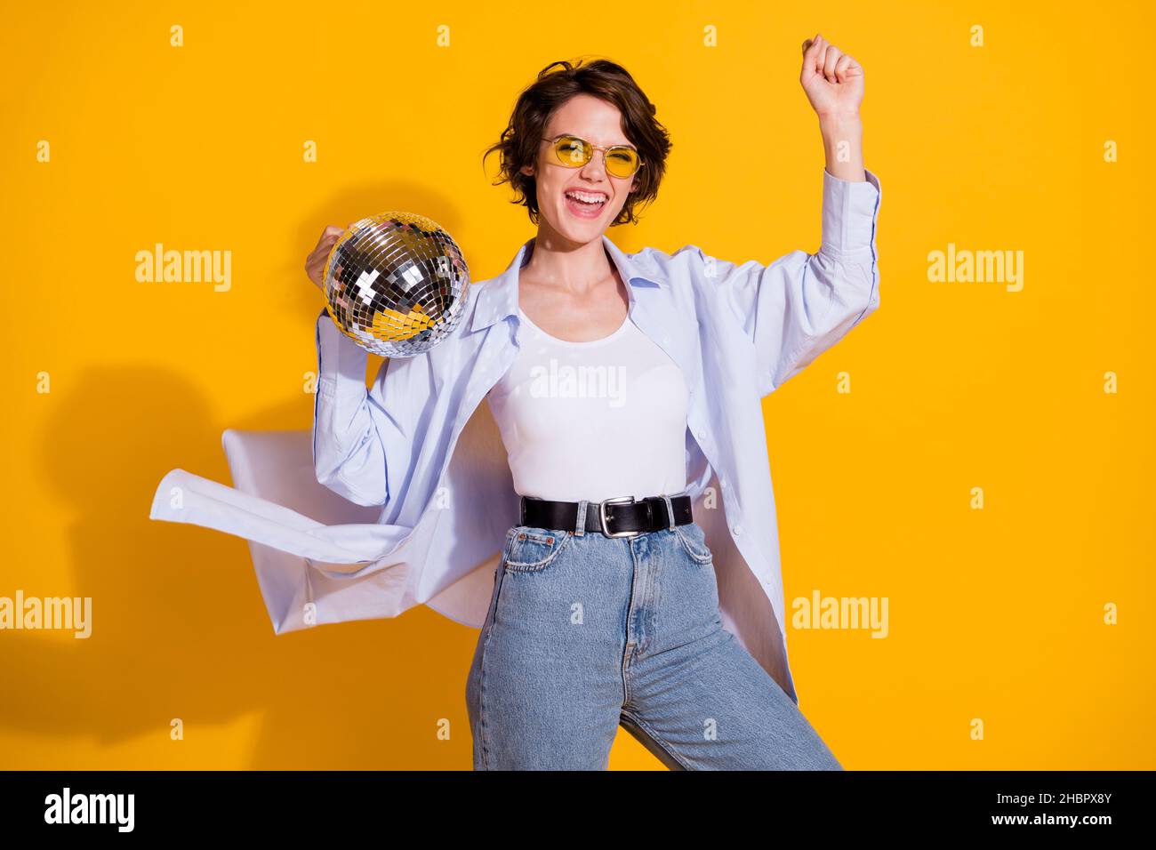 Photo portrait of beautiful female hipster dancing at party keeping