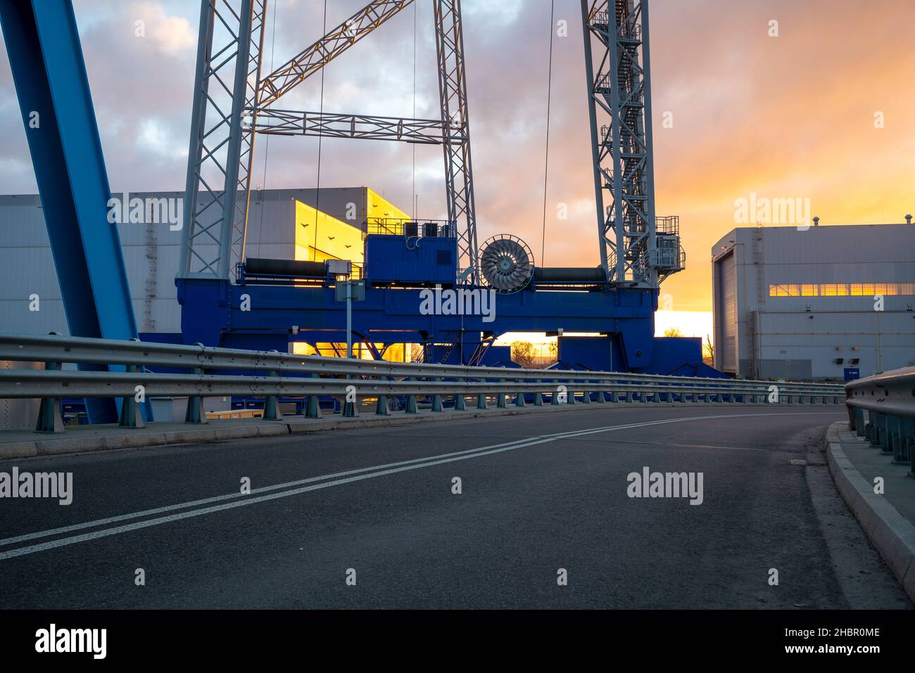 Asphalt road leading through an industrial area,image perfect as a background for 3d rendering Stock Photo
