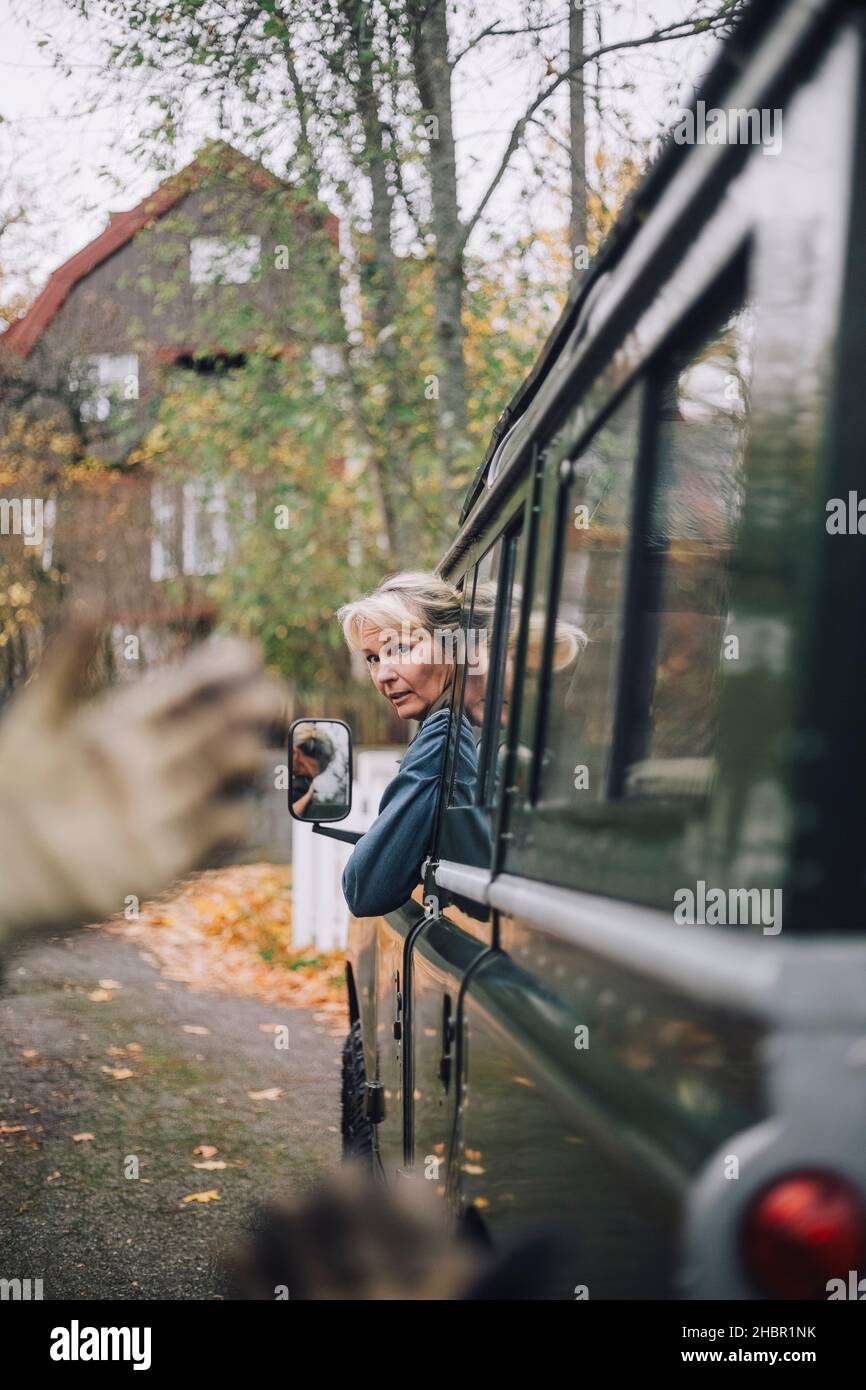 Mature woman looking out of sports utility vehicle Stock Photo