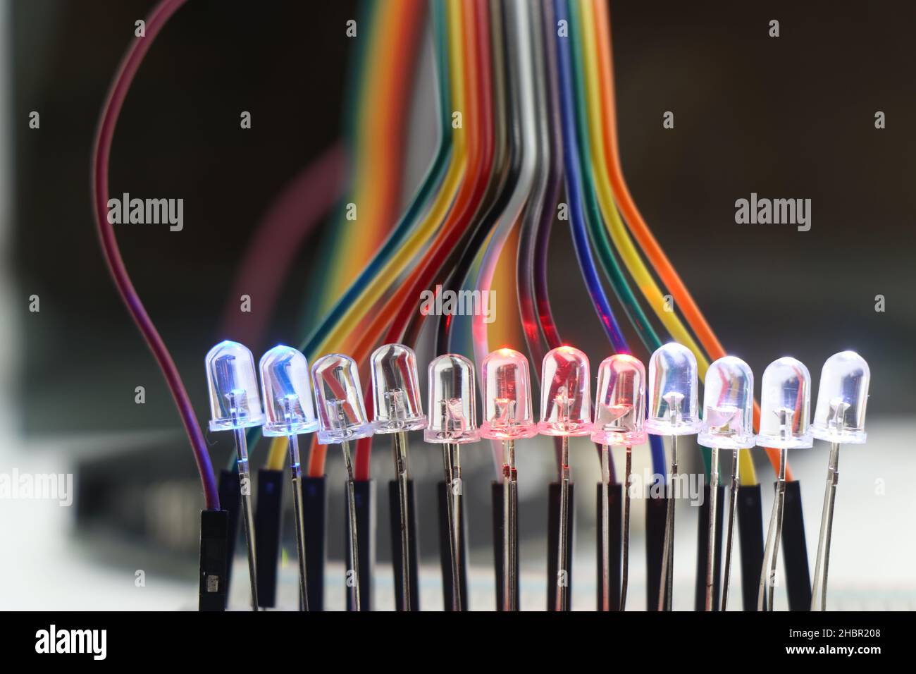 Light emitting diode or LED with glowing lights arranged in a breadboard and connected with jumper wires Stock Photo