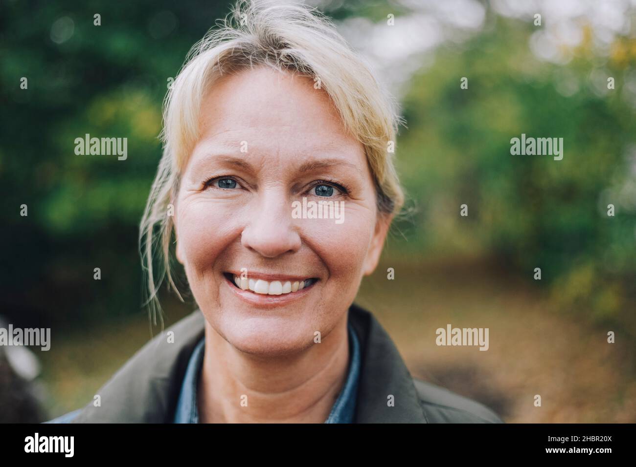 Smiling mature woman in back yard Stock Photo