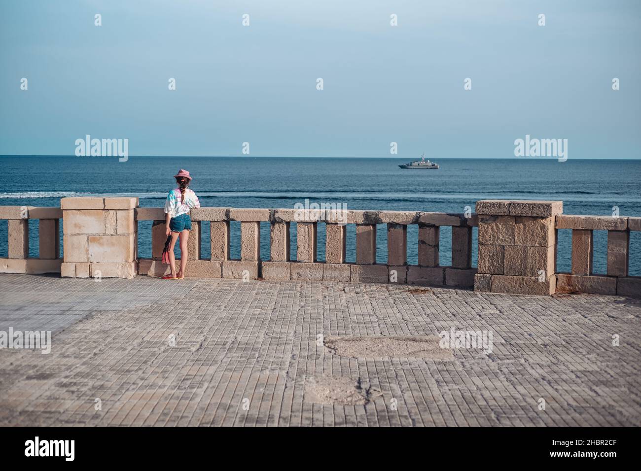 Santa Maria di Leuca, Italy-June 2021: a little girl lookink over the sea Stock Photo