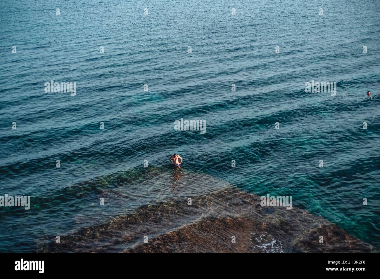 Santa Maria di Leuca, Italy-June 2021: a boy swimming in the beautiful sea of Puglia Stock Photo