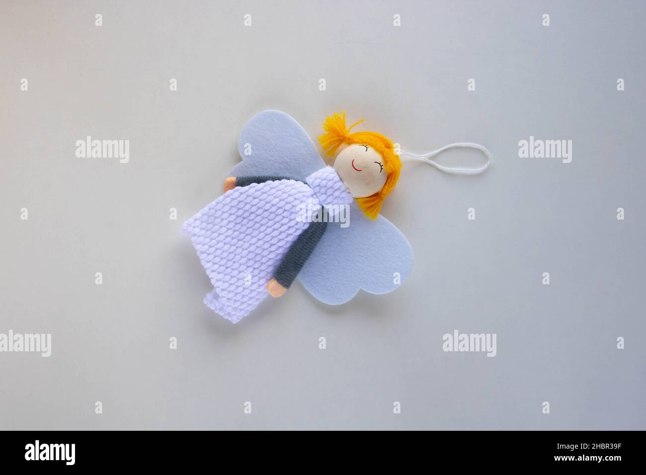 Christmas decoration Angel with wings lies on a white background. Stock Photo