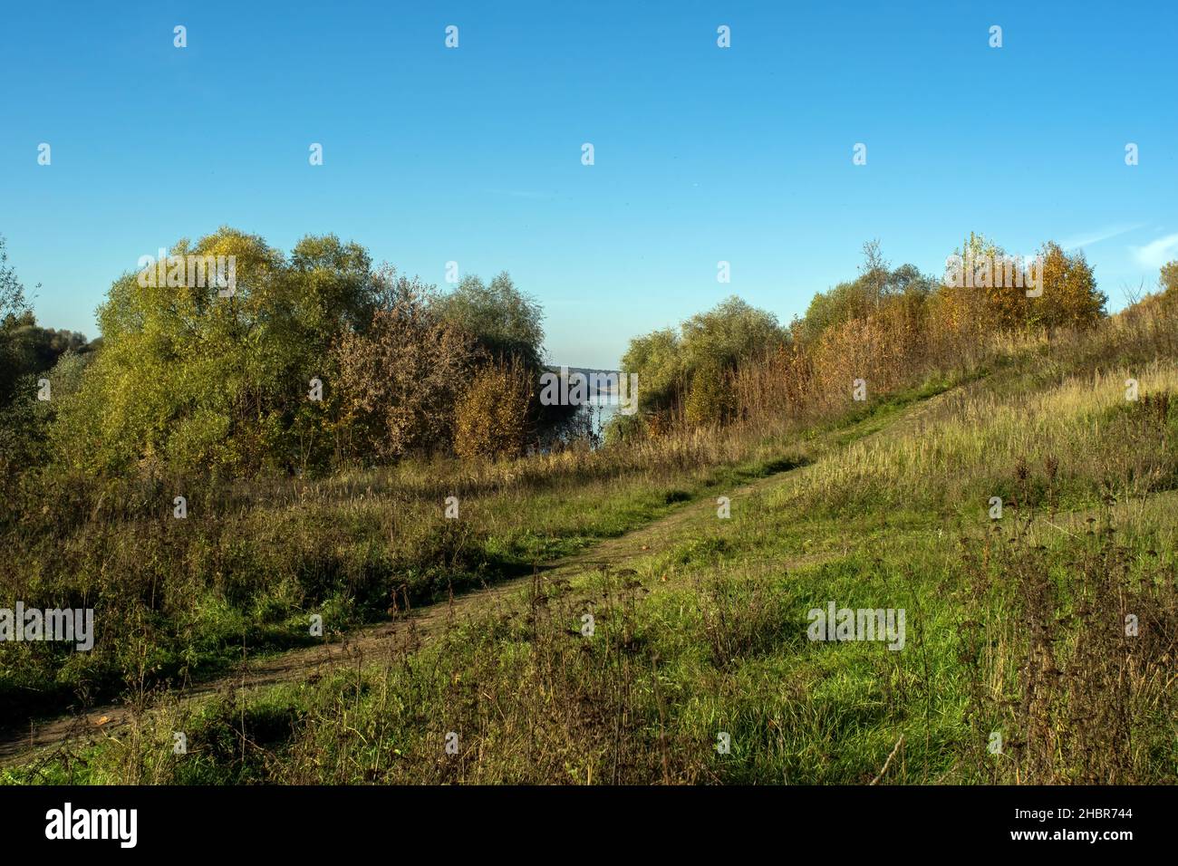 the bank of a large river on a clear day, in autumn Stock Photo