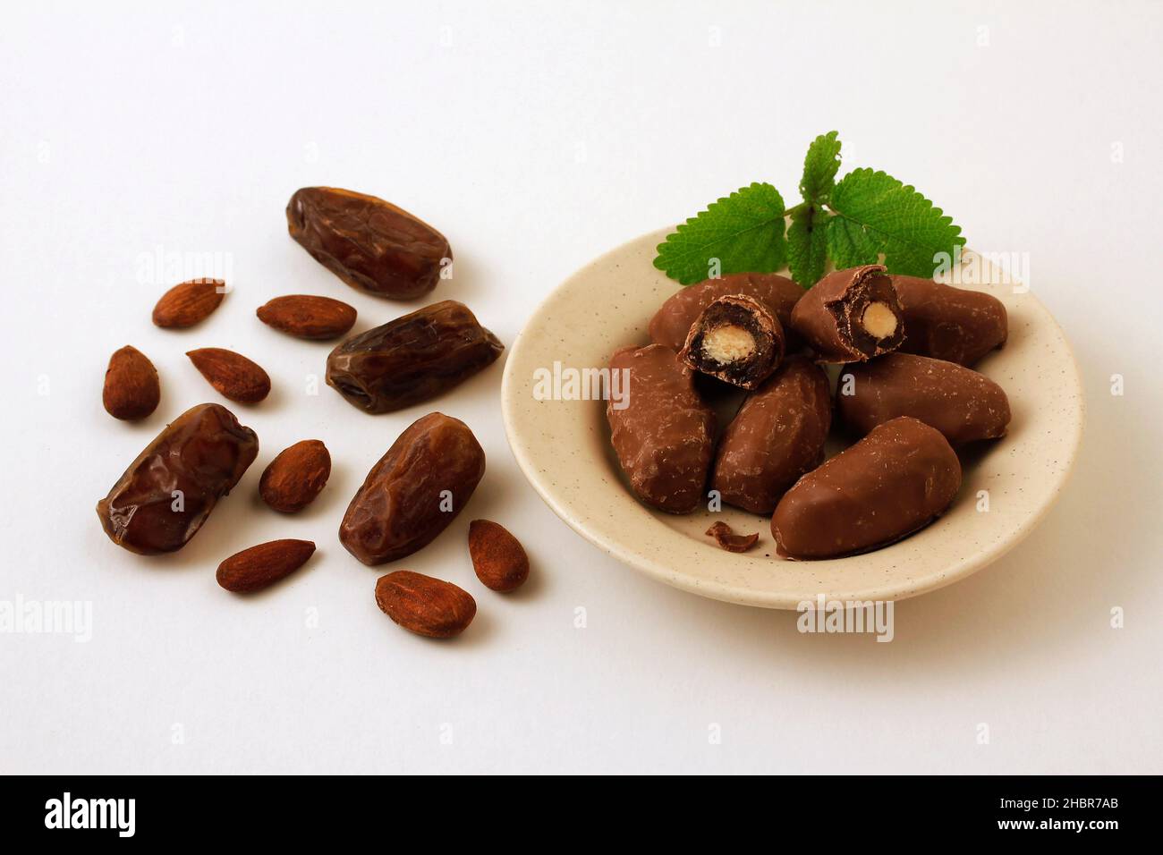 Dates with almond. Covered with milk chocolate. Stock Photo