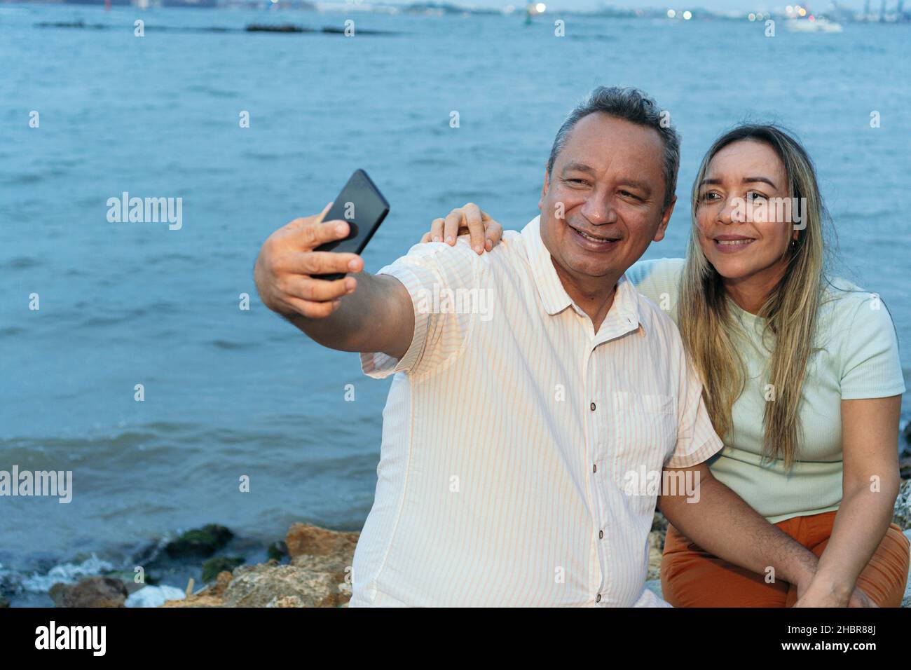 Couple in their fifties taking a selfie with their cell phone Stock Photo