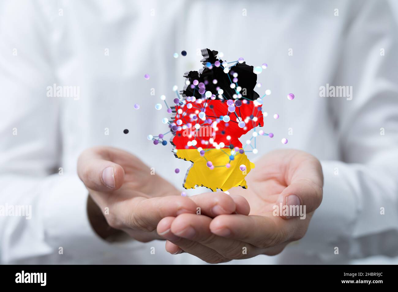 A male hand touching 3D rendered German map with its flag colors with ...