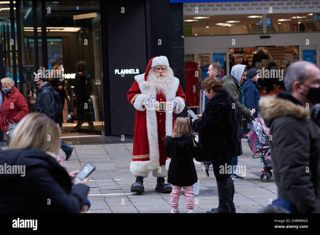 Newcastle, UK. 21st December, 2021. Busy crowds shopping on Northumberland Street as a Santa Claus enteratains them in, UK. Credit: Garry Cook/Alamy Live News. Stock Photo