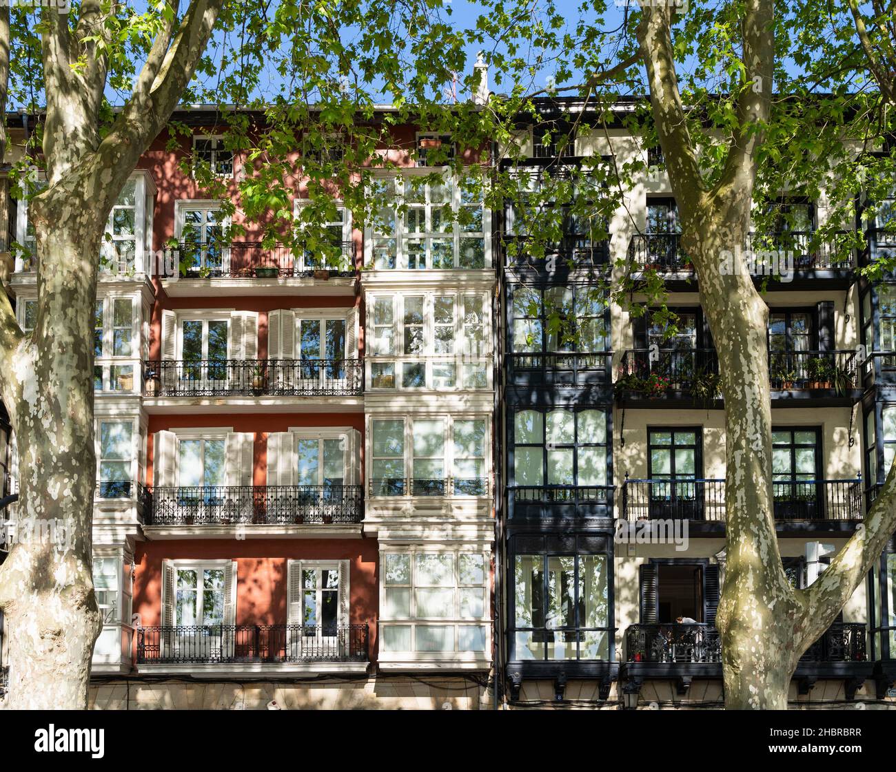 Residential building facade in Bilbao old town city with shadows of ...