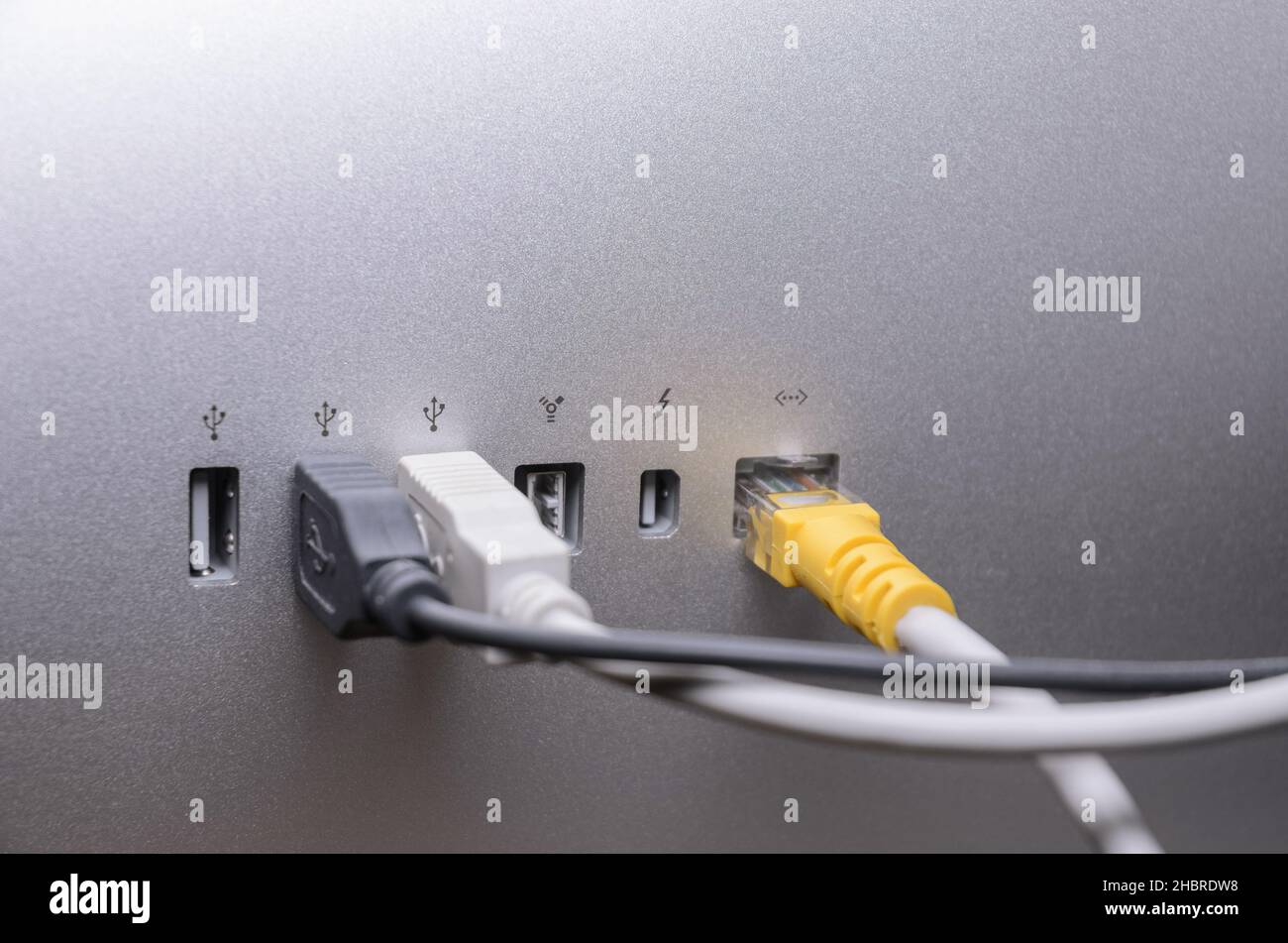 USB, Thunderbolt and cables connected to ports on the back of an Apple Thunderbolt