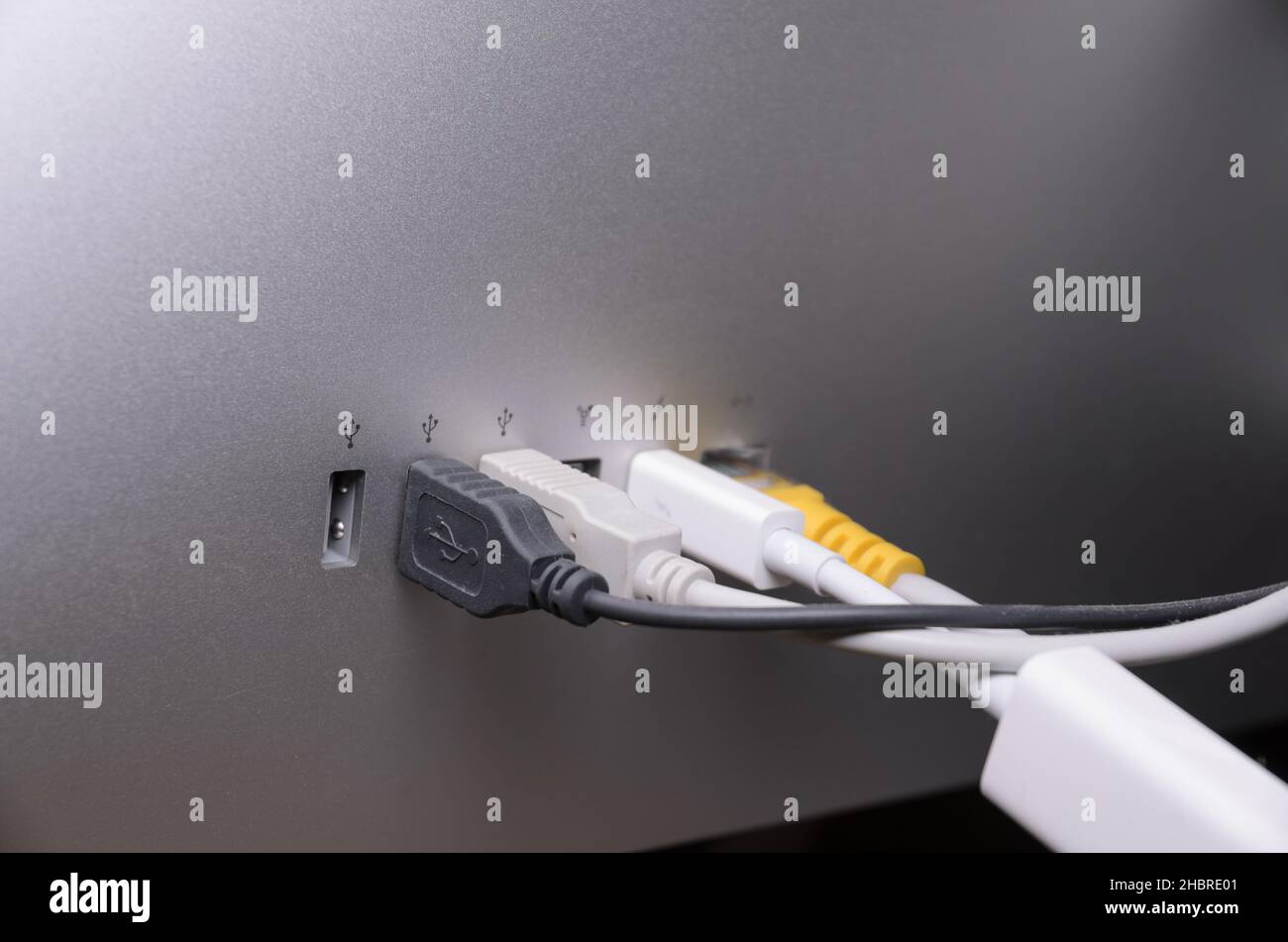 USB, Thunderbolt and cables connected to ports on the back of an Apple Thunderbolt